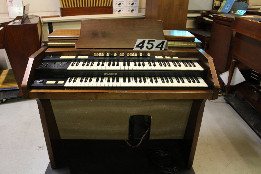 454 is a Hammond A-205 in a walnut finish equipped with a transposer, built-in speakers, and has an output for MIDI! Serial #01010285