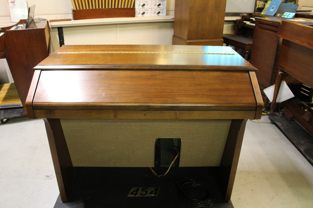 454 is a Hammond A-205 in a walnut finish equipped with a transposer, built-in speakers, and has an output for MIDI! Serial #01010285