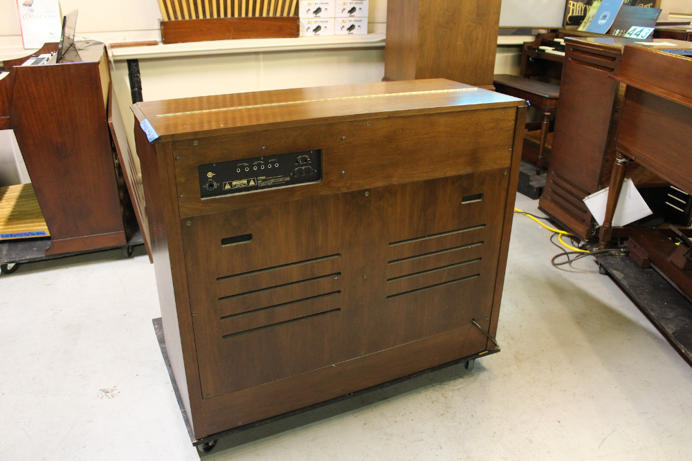 454 is a Hammond A-205 in a walnut finish equipped with a transposer, built-in speakers, and has an output for MIDI! Serial #01010285