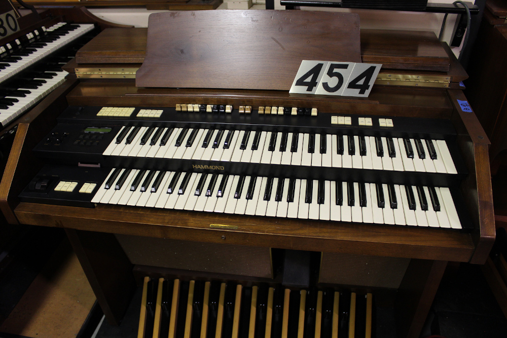 454 is a Hammond A-205 in a walnut finish equipped with a transposer, built-in speakers, and has an output for MIDI! Serial #01010285 
