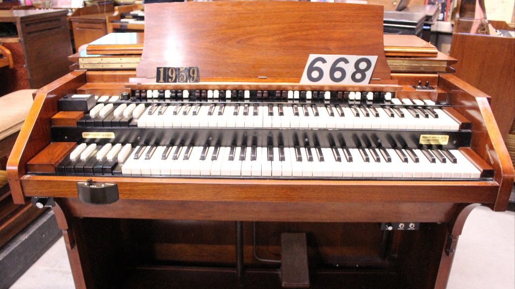 668 is a 1959 Hammond C3 in a Walnut finish for sale.